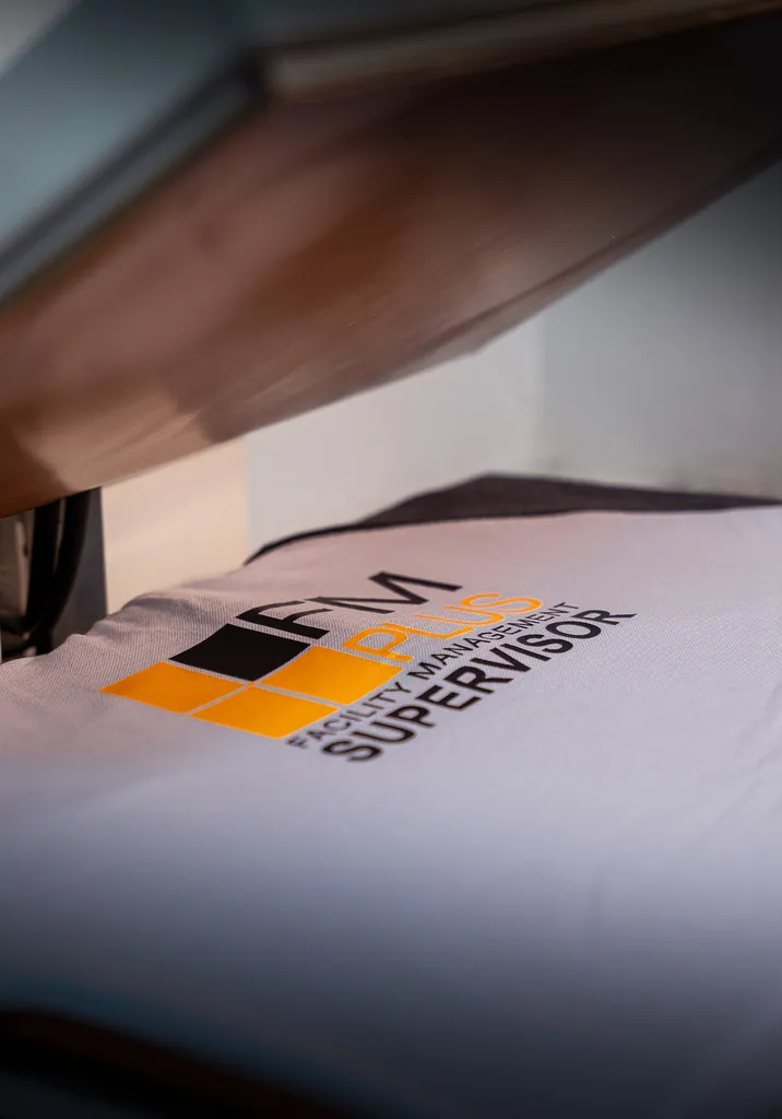 Heat-press transfer applying a logo to a garment