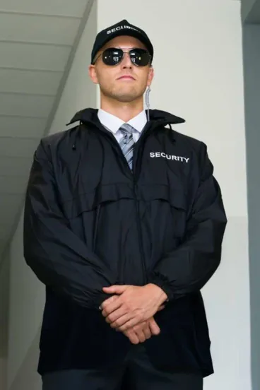 Security officer in a black uniform and cap