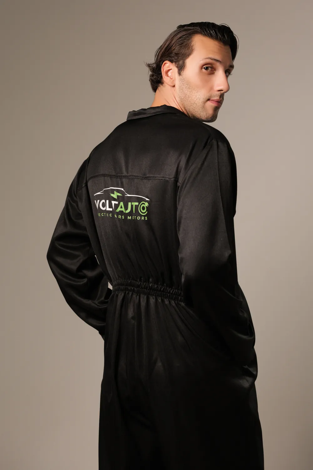 Technician wearing a black Volt Auto coverall