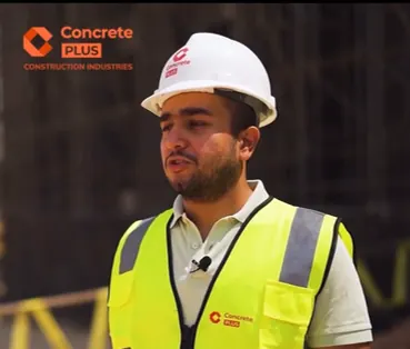 Concrete Plus engineer in a white helmet and branded hi-vis vest