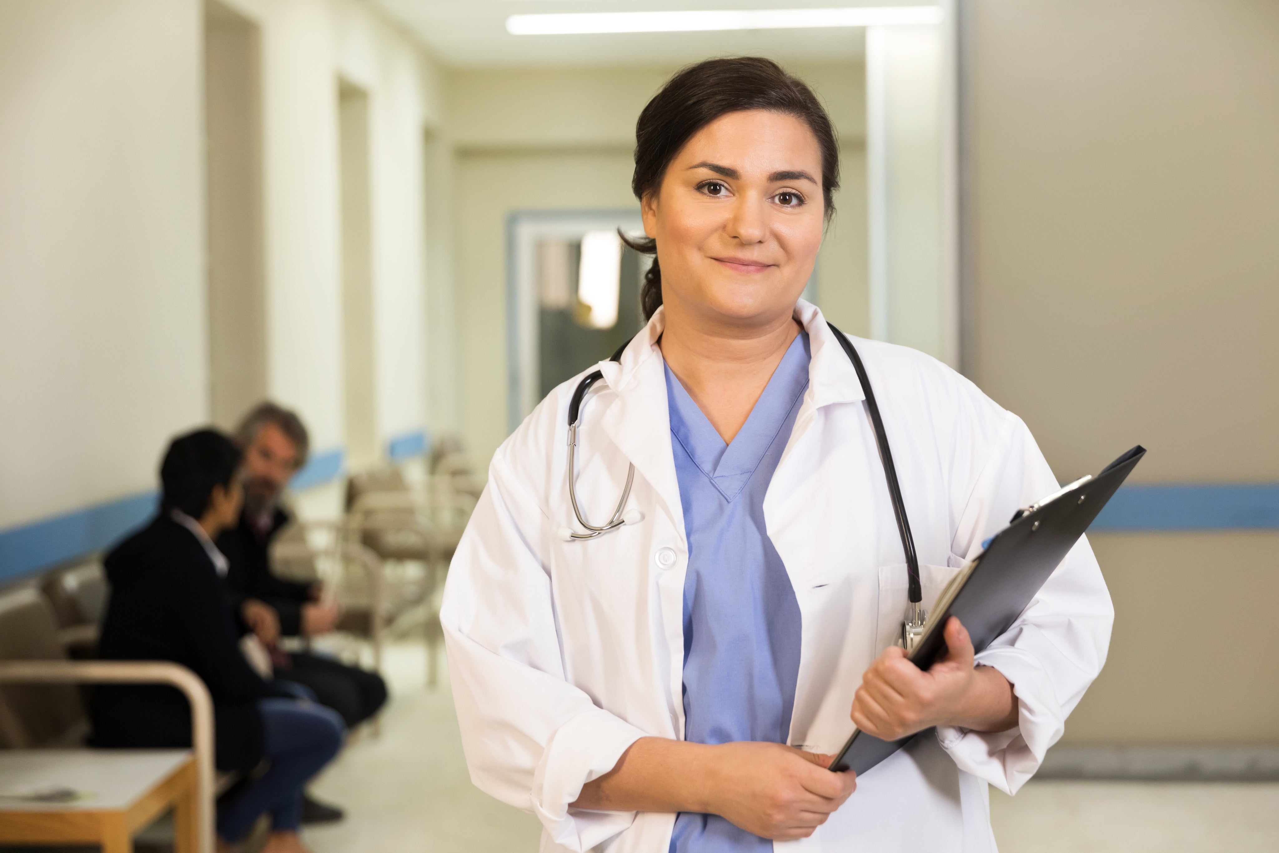 a-doctor-smiles-while-holding-her-clipboard.jpg