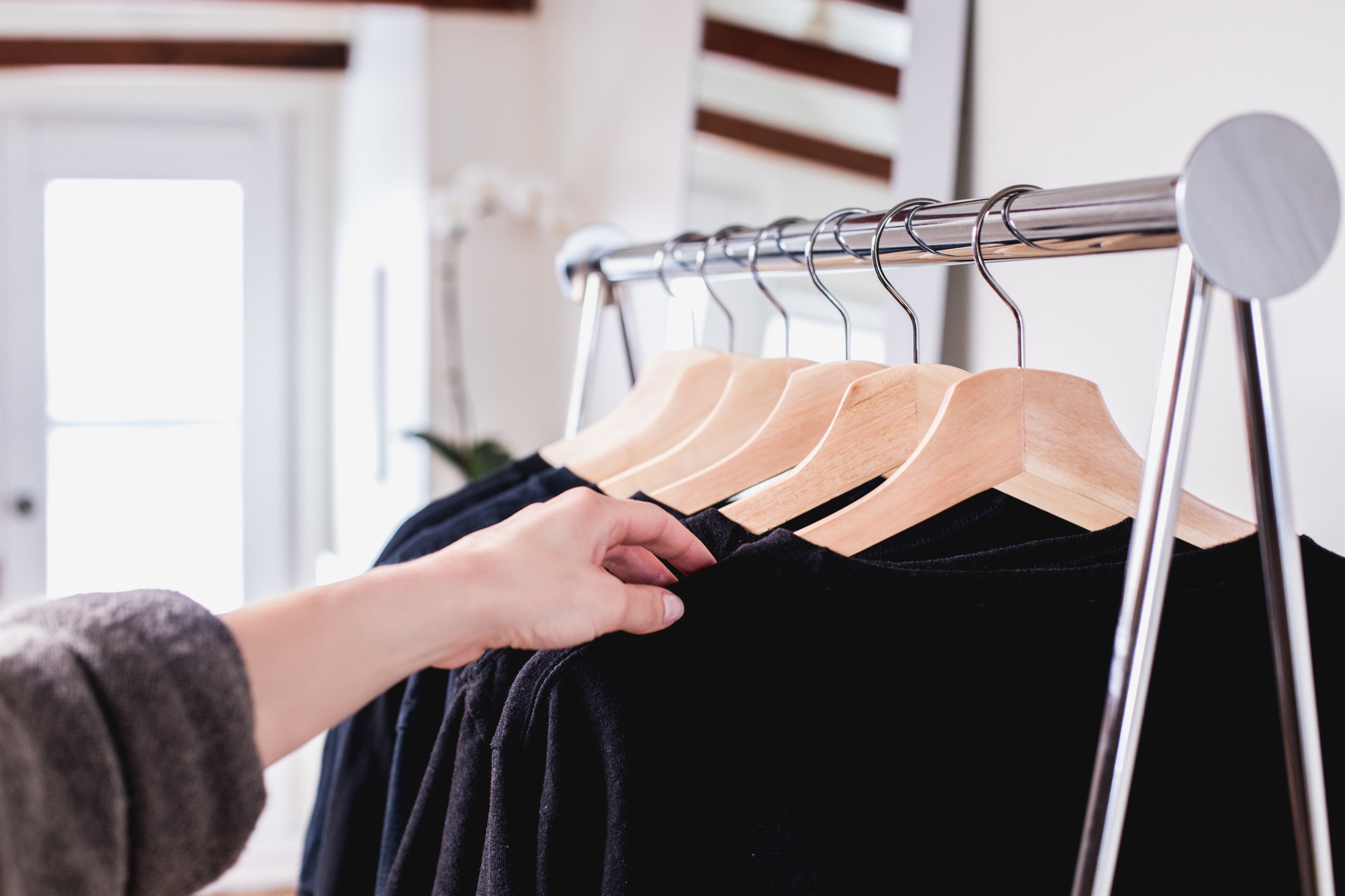 holding-a-sweater-on-a-clothing-rack.jpg